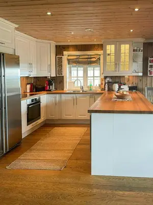 a kitchen with white cabinets and a stainless steel refrigerator at Cabin With Ski Inski Out In Rauland in Rauland