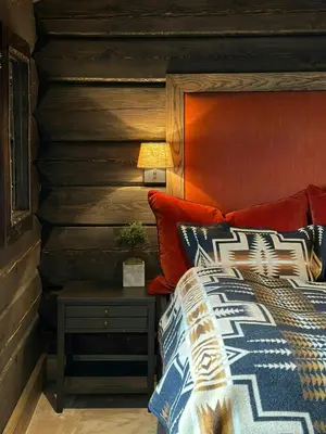 a bedroom with a bed and a wooden wall at Architect-Designed Mountain Cabin At Mosetertoppen in Øyer