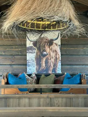 a picture of a cow hanging on a wall at Architect-Designed Mountain Cabin At Mosetertoppen in Øyer