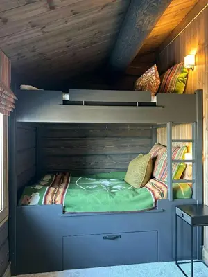 a bedroom with a bunk bed in a cabin at Architect-Designed Mountain Cabin At Mosetertoppen in Øyer