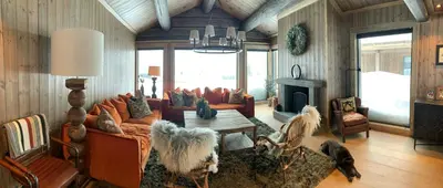 a living room with a couch and a table at Architect-Designed Mountain Cabin At Mosetertoppen in Øyer
