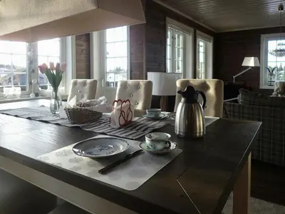 a dining room table with a tea kettle and plates at Mountain Cabin With Views Over Nesfjellet in Nesbyen