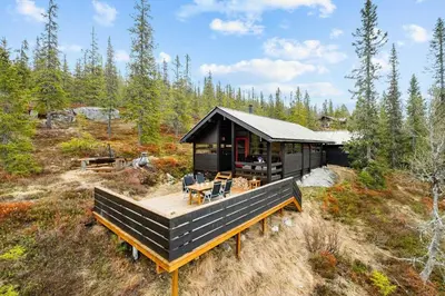 a cabin in the woods with a deck at Close To Nature In Ål Cabin At Haglebu in Eggedal