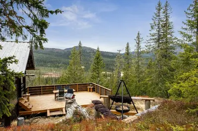 a house with a deck with a swing at Close To Nature In Ål Cabin At Haglebu in Eggedal