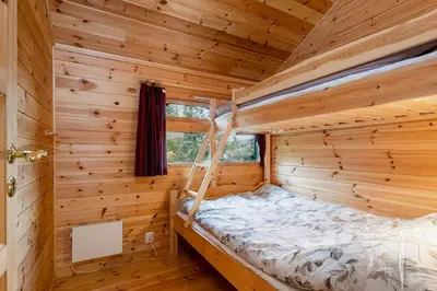 a bedroom in a log cabin with a bed in it at Close To Nature In Ål Cabin At Haglebu in Eggedal