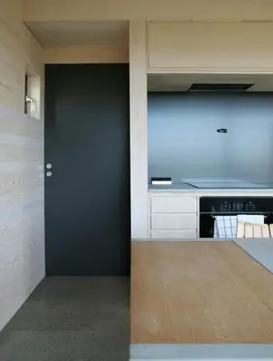 a kitchen with a black door and a stove at Cabin Overlooking Hallingskarvet National Park in Geilo