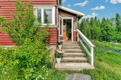 a red house with stairs leading to the front door at Peaceful Smallholding With Yoga Studio in Traut