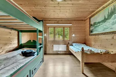 a bedroom with two bunk beds in a wooden cabin at Peaceful Smallholding With Yoga Studio in Traut
