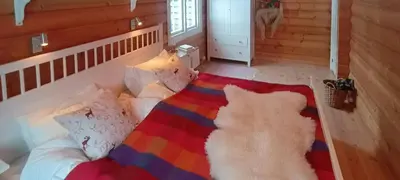 a room with a bed with a colorful blanket and pillows at Cabin With Sauna In Vegglifjell in Veggli
