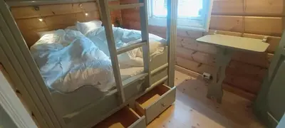 a small bedroom with a bed in a glass cabinet at Cabin With Sauna In Vegglifjell in Veggli
