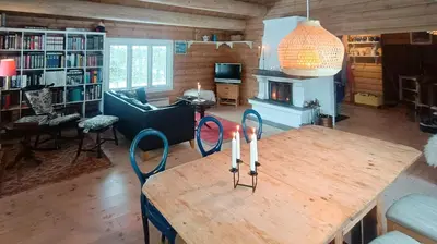 a living room with a wooden table and chairs at Cabin With Sauna In Vegglifjell in Veggli