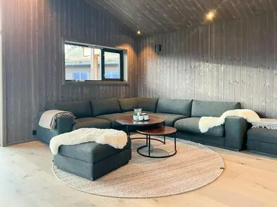 a living room with a couch and a table at Stylish Cabin In Scenic Stryn in Stryn