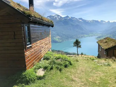 a building on a hill with a view of a lake at Stylish Cabin In Scenic Stryn in Stryn