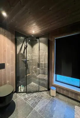 a bathroom with a shower with a glass door at Stylish Cabin In Scenic Stryn in Stryn