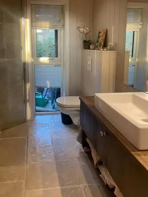 a bathroom with a tub and a sink and a toilet at Sunny Cabin With Fjord Views In Redal in Naustdal i Sunnfjord