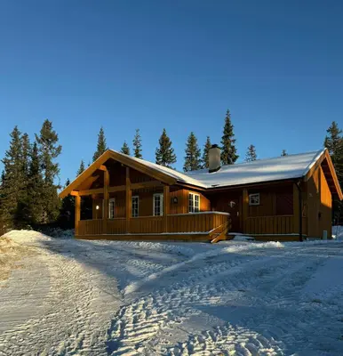 a log cabin in the snow with a driveway at Family-Friendly Cabin In Nordseter Near Ski Trails in Lillehammer