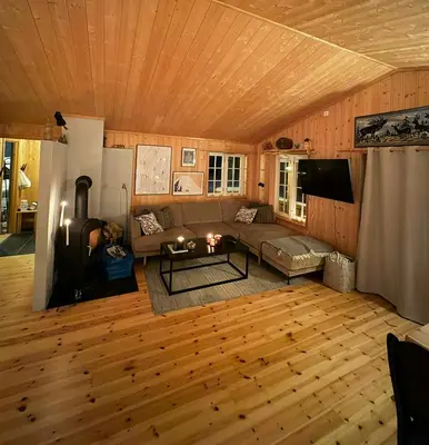 a living room with a couch and a table at Family-Friendly Cabin In Nordseter Near Ski Trails in Lillehammer