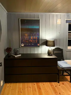 a dresser with a lamp on it in a room at Family-Friendly Cabin In Nordseter Near Ski Trails in Lillehammer