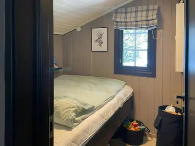 a small bed in a room with a window at Cabin By The Cross-Country Trails In Norefjell in Eggedal