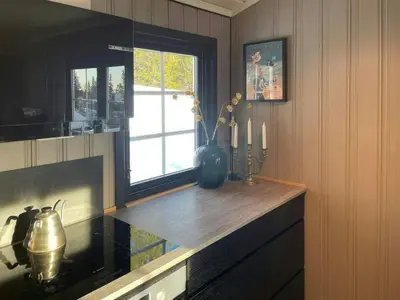 a kitchen with a counter top and a window at Cabin By The Cross-Country Trails In Norefjell in Eggedal