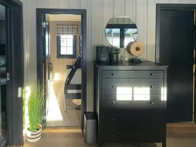a room with a dresser and a mirror and stairs at Cabin By The Cross-Country Trails In Norefjell in Eggedal