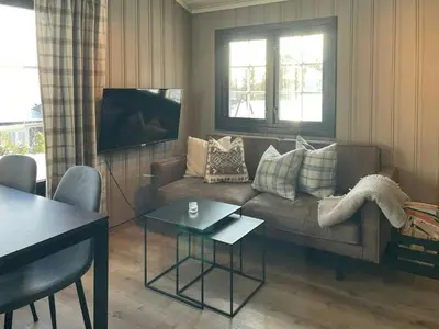 a living room with a couch and a table at Cabin By The Cross-Country Trails In Norefjell in Eggedal