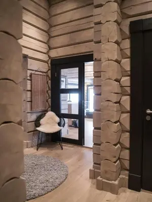 a room with a stone wall with a door and a chair at Spacious Mountain Cabin With Lodge Style In Oppdal in Oppdal