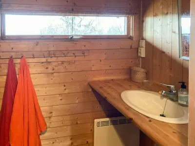 a wooden bathroom with a sink and a sink at Ålhytte Near Vasetvannet in Ron
