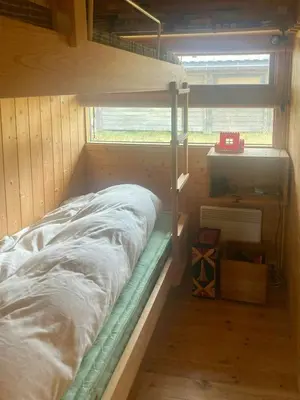 a bunk bed in a room with a window at Ålhytte Near Vasetvannet in Ron