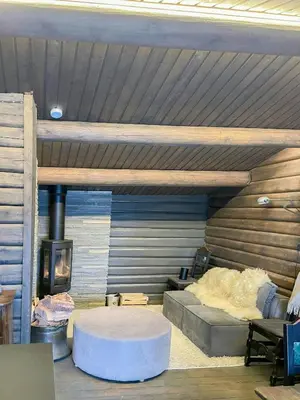 a room with a bed and a fireplace in a cabin at Log Cabin With Views Over Trysil Mountain in Trysil