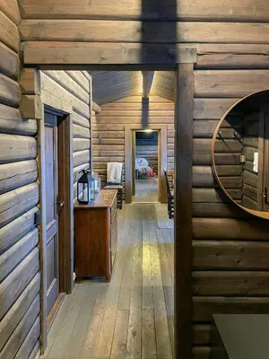 a hallway in a log cabin with a mirror at Log Cabin With Views Over Trysil Mountain in Trysil