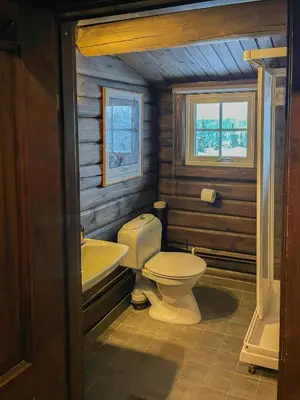 a bathroom with a toilet and a sink at Log Cabin With Views Over Trysil Mountain in Trysil