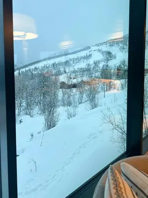 a view of a snow covered field from a window at Unique Cabin With Spa And Ski In-Ski Out in Hemsedal