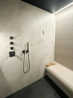 a bathroom with a shower with a bath tub at Unique Cabin With Spa And Ski In-Ski Out in Hemsedal