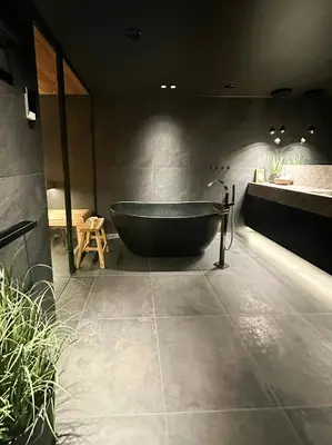 a bathroom with a black tub and a sink at Unique Cabin With Spa And Ski In-Ski Out in Hemsedal