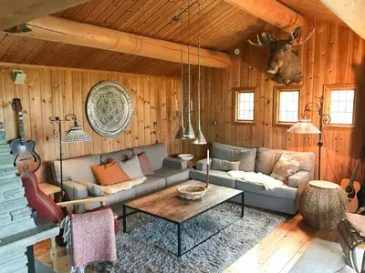 a living room with a couch and a table at Mountain Cabin Views Of Hills And Lake in Ron