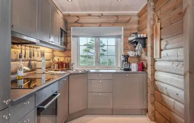 a kitchen with wooden cabinets and a window at Amazing Home In Lesjaskog With Wifi in Bjorli