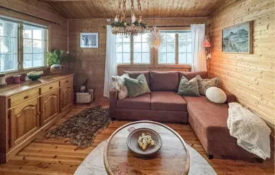 a living room with a couch and a table at 2 Bedroom Pet Friendly Home In Rendalen in Rendalen