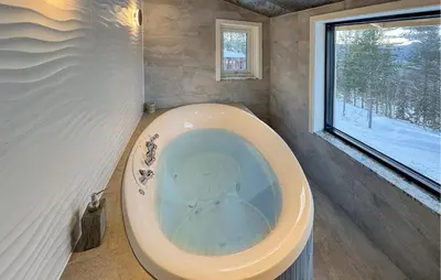 a bath tub in a bathroom with a window at 2 Bedroom Pet Friendly Home In Rendalen in Rendalen