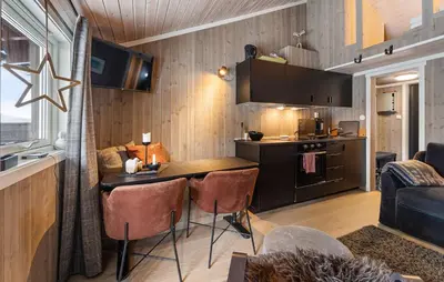 a kitchen and living room with a table and chairs at Amazing Apartment In Hovden I Setesdal in Hovden