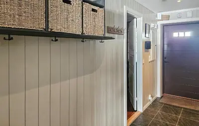 a hallway with wicker baskets on the wall and a blue door at Lovely Apartment In Rjukan With Wifi in Rjukan