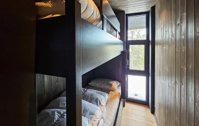 two bunk beds in a room with a window at Awesome Home In Rjukan With Sauna in Rjukan