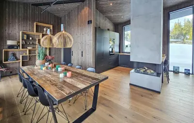 a dining room with a table and a fireplace at Awesome Home In Rjukan With Sauna in Rjukan