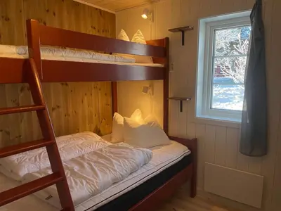 a bedroom with two bunk beds and a window at New 4Bedroom Cabin With Sauna, Terrace & Fireplace in Beitostøl