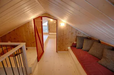 a living room with a couch in the attic at New 4Bedroom Cabin With Sauna, Terrace & Fireplace in Beitostøl