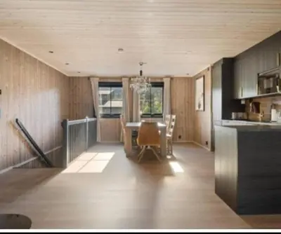 a kitchen and dining room with a table and chairs at Trysil turistesenter hytte in Trysil