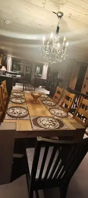 a dining room with a large table and a chandelier at Trysil turistesenter hytte in Trysil
