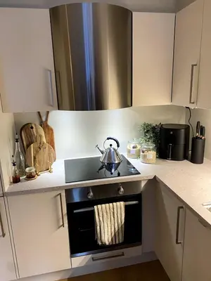 a kitchen with a stove with a tea pot on it at Modern, big and central apartment in Trondheim in Trondheim