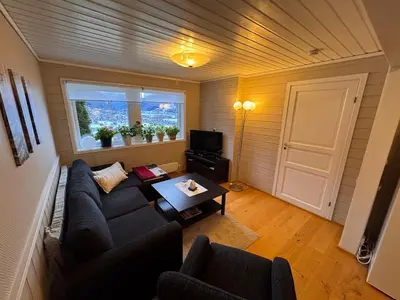 a living room with a couch and a table at 2 roms kjellerleilighet med separat soverom in Luster
