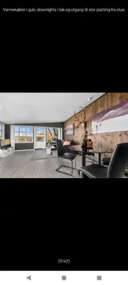 a living room with two chairs and a table at Ski inn Ski Out Best holiday Apartments i Oppdal in Oppdal